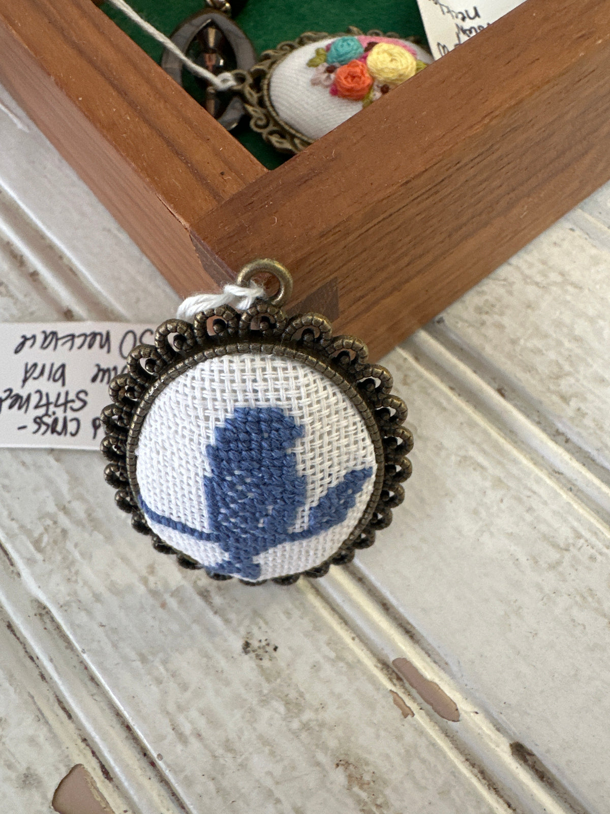 Hand Cross-stitched blue bird necklace