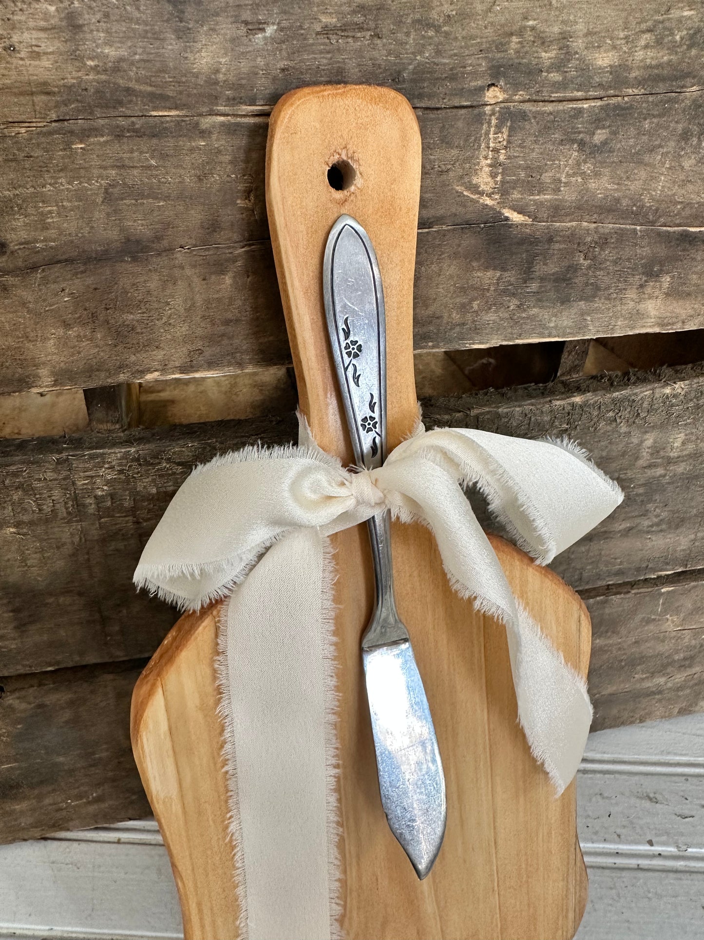 Handmade wood bread board with silver plate butter knife